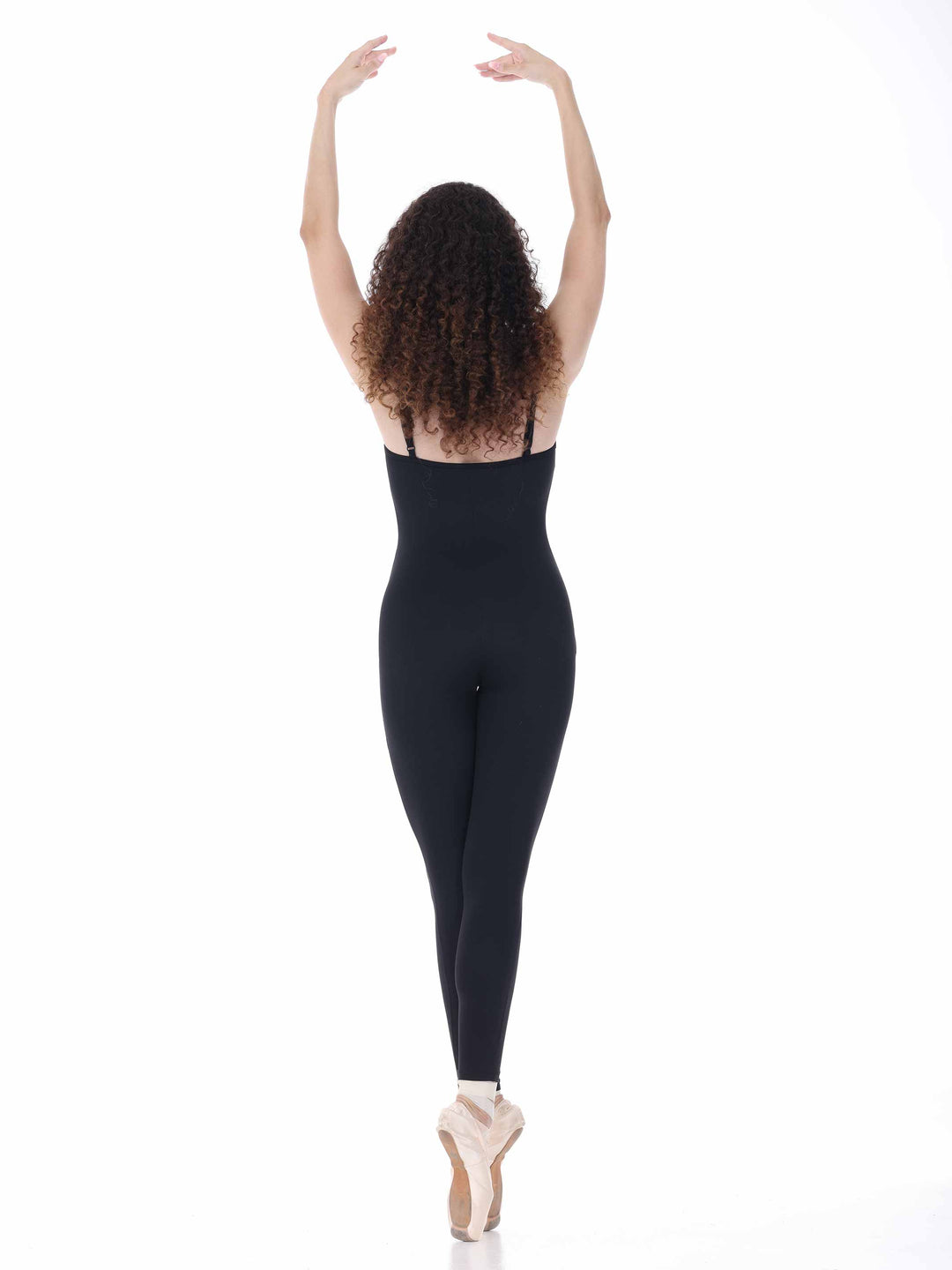 Vue arrière d’une danseuse en unitard noir, bras levés – tenue de danse Sway inspirée du style classique.