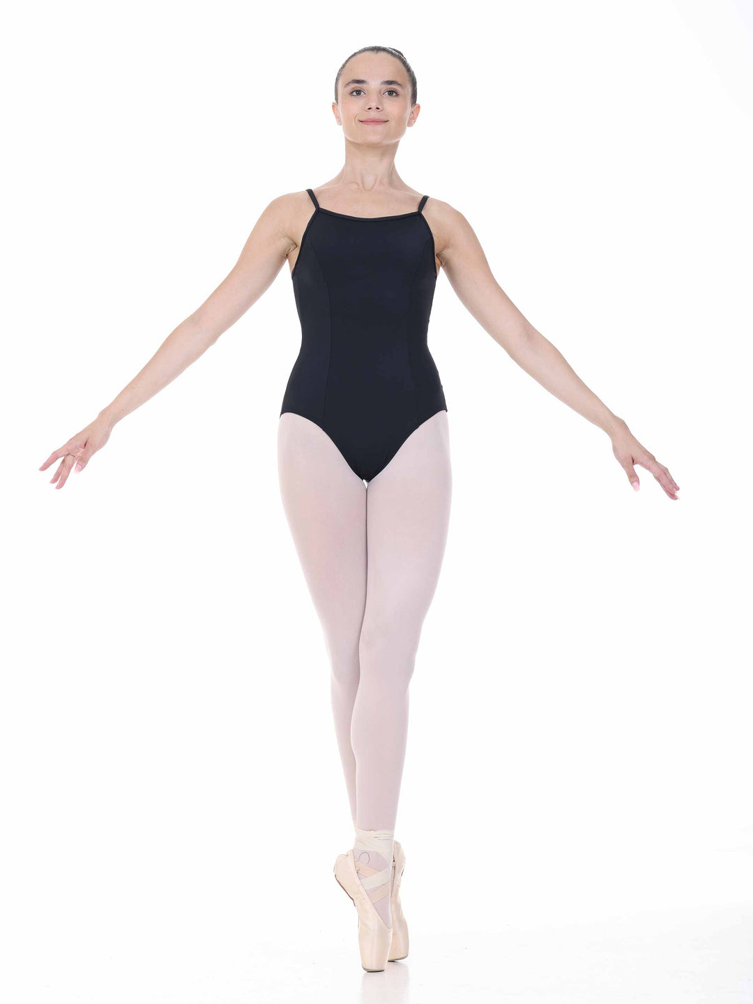 Danseuse en position de ballet sur pointes, vêtue d’un justaucorps noir – tenue féminine pour pratique de danse.